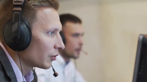 Male Call Center Agent in Wireless Headset Consulting Online Client. Using Computer, Business Men