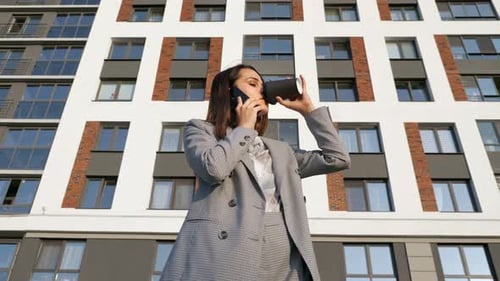 Professional Woman Talking on Phone with Coffee