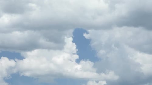 Clouds Drifting Slowly Across Blue Sky