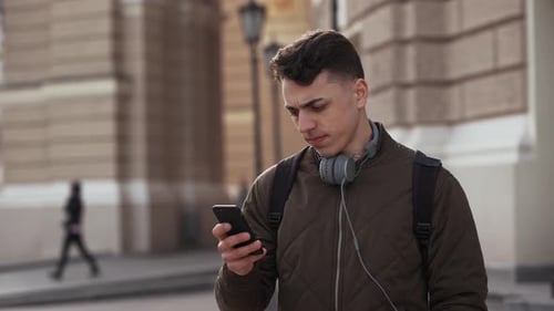 Young Adult Using Smartphone in Urban Setting