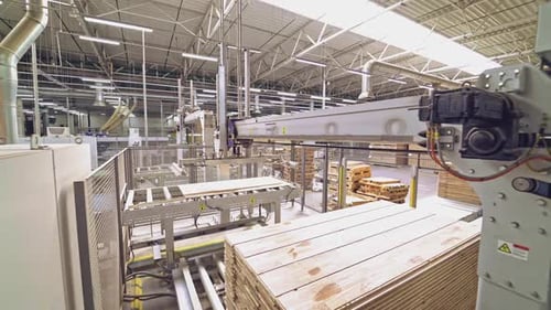 Automated Machinery Processing Wood Planks in Factory