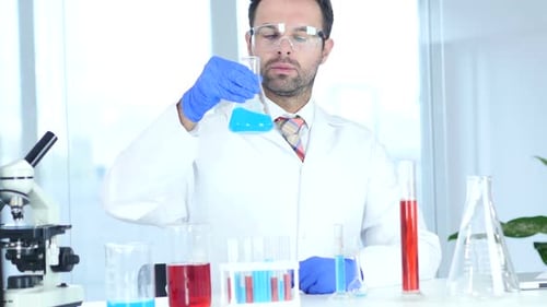Scientist Holding Flask with Blue Liquid in Lab