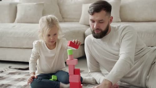 Father and Daughter Building Tower with Blocks