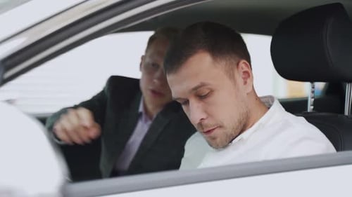 Two Young Adults Conversing in Car