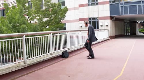 Man in Suit Dancing on a Pedestrian Bridge