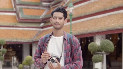 Young Adult Taking Pictures at Historic Temple
