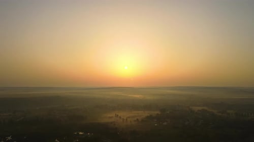 Aerial View Foggy Sunrise Over Residential Houses in Suburban Rural Area