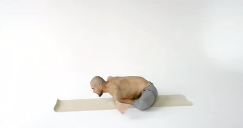 Man Stretching During Yoga in Studio