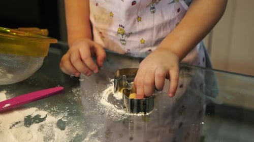 Child making cut-out cookies