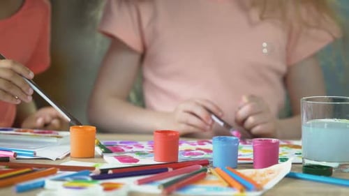 Closeup of Two Young Girls Painting a Picture at Preschool Art Club, Hobby