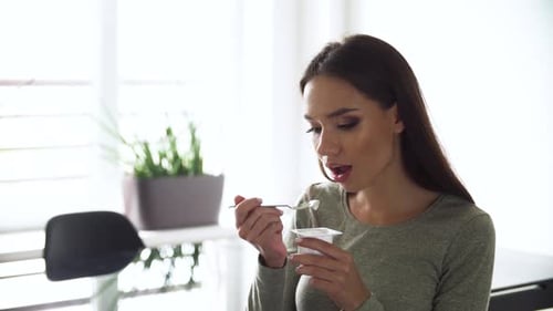 Woman Eating Yogurt for Healthy Lifestyle Snack