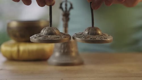Ting Sha Bells Held by Hand Close Up