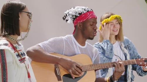 Three Musicians Singing Together with Acoustic Guitar