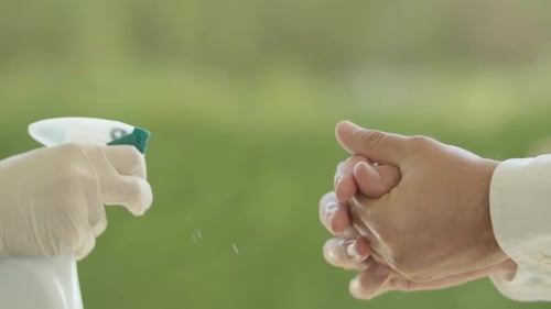 Adult Hands Sanitized with Hand Sanitizer Spray