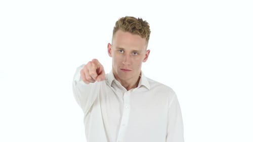 Young Man Points at Camera in Studio