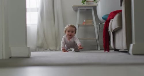 Close up of caucasian baby crawling on the floor at home