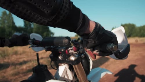 Rider Gripping Handle Bars on Dirt Bike