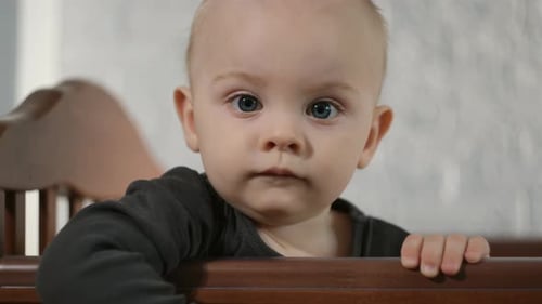 Baby Smiling in a Crib Close Up
