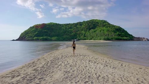 Woman Walks to Tropical Island on Sandbar