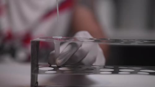 Careful Laboratory Procedure with Pipette and Test Tube