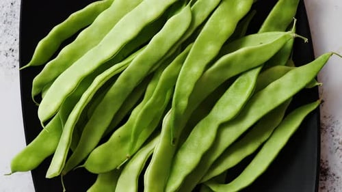 Black Ceramic Plate with Fresh Green Bean Pods