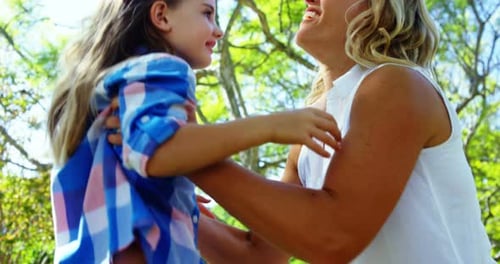Mother and daughter having fun in park 4k