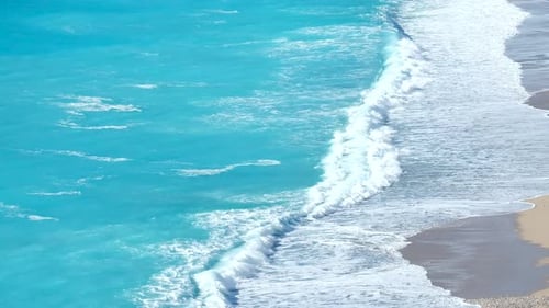 Waves On The Beach Sand