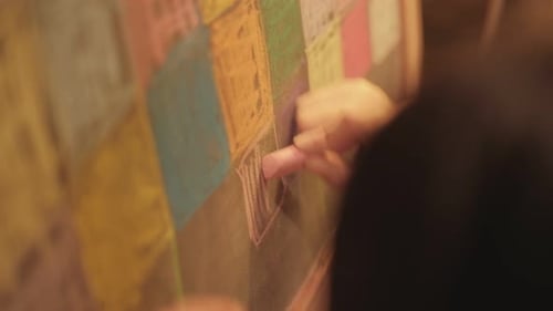 Child Drawing on Chalkboard with Colorful Chalk