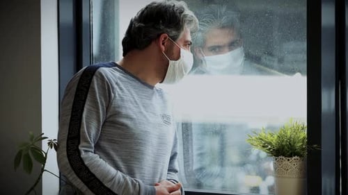 Man With Mask Standing By Window Inside