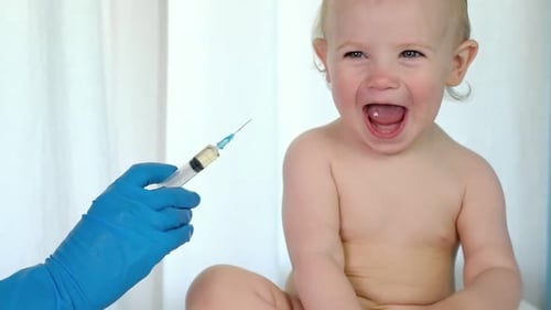 Doctor Vaccinating Baby in Clinic