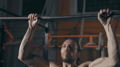 Man Doing Pull Ups in Gym Close Up