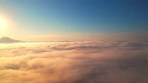 4K Drone Flying in the clouds. Flying through the clouds during sunrise