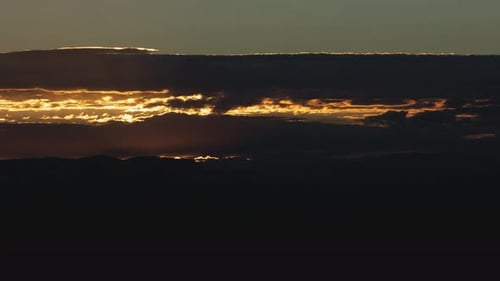 Vibrant Sunrise Illuminating Mountain Landscape with Clouds