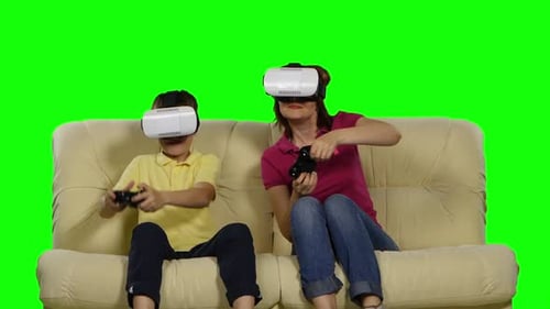 Virtual Reality Mask. Young Mother and Her Son with Pleasure Play with the Head-mounted Display