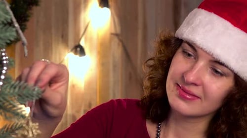 Woman Decorating Christmas Tree in Cozy Home