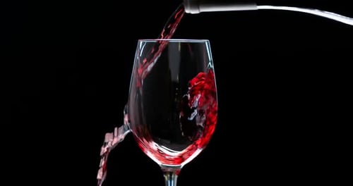 Pouring Red Wine into a Glass on Black