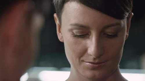 Woman Adjusting Heart Earring in Mirror