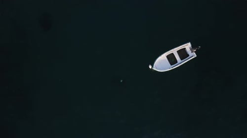 Aerial view of white Boat in the Sea. Flying above Boat. Alone boat in the Ocean