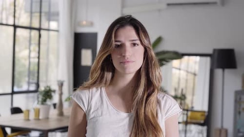 Young Woman Looking Directly at Camera Indoors
