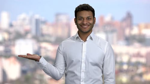 Handsome Businessman Presenting Something in His Palm