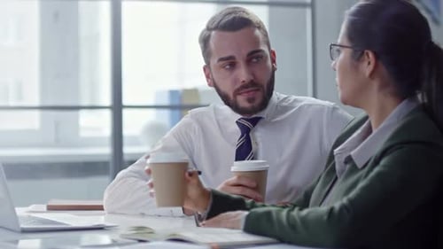Colleagues Talking over Coffee in Office
