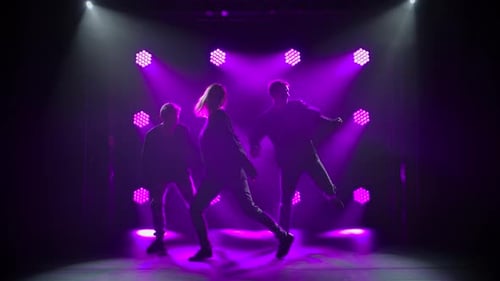 Silhouettes of a Talented Group Young Hip Hop Dancers. Hip Hop Street Dance on a Stage in Dark
