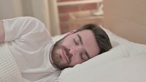 Man Sleeping Peacefully in Bed Close Up