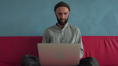 Man Using Laptop at Home