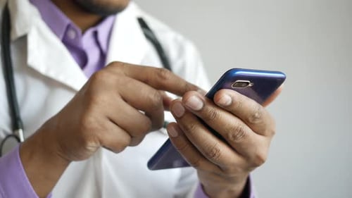 Doctor Using Smartphone in Clinic
