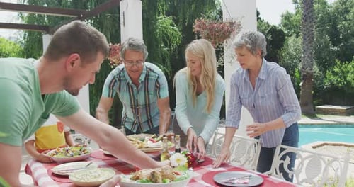 Family Prepares Lunch Together in Garden Setting