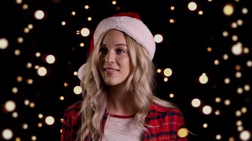 Smiling Woman in Santa Hat with Bokeh Background