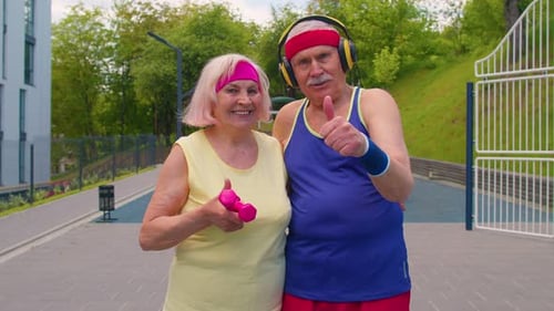 Smiling Senior Couple Exercising Outdoors Together