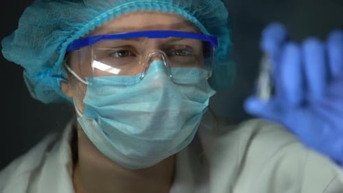 Scientist Holding Ampule With Transparent Liquid, Healthcare and Vaccination