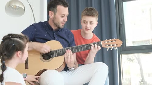 Dad Plays Guitar with Kids at Home